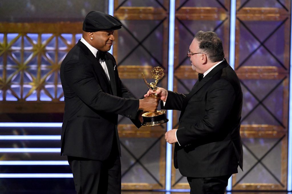 LOS ANGELES, CA - SEPTEMBER 17:  Director Bruce Miller (R) accepts the Outstanding Directing for a Limited Series, Movie, or Dramatic Special award for "Big Little Lies" from actor LL Cool J onstage during the 69th Annual Primetime Emmy Awards at Microsoft Theater on September 17, 2017 in Los Angeles, California.  (Photo by Kevin Winter/Getty Images)