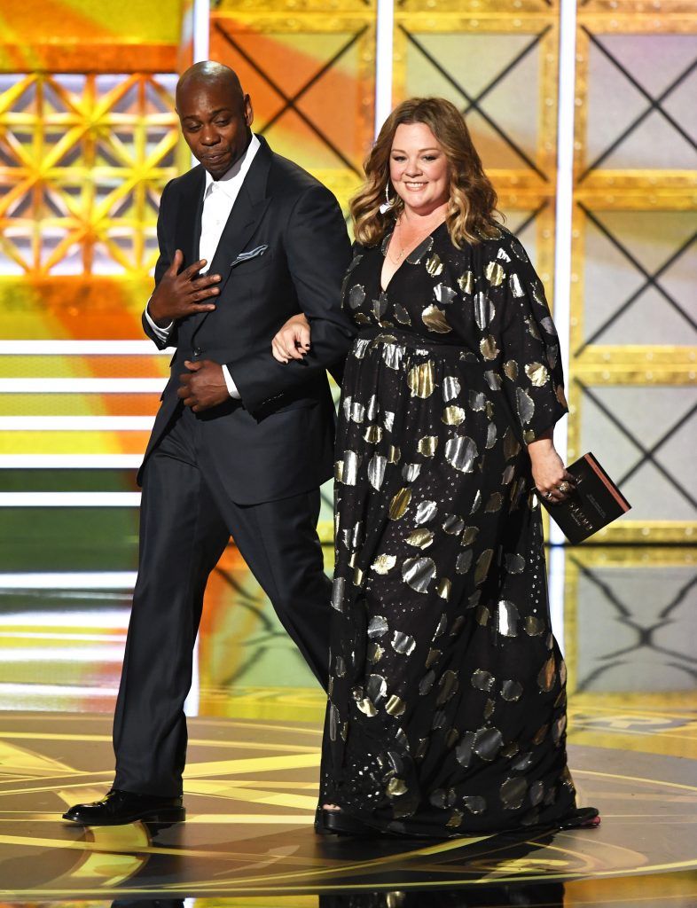 LOS ANGELES, CA - SEPTEMBER 17:  Comedian Dave Chappelle (L) and actor Melissa McCarthy walk onstage during the 69th Annual Primetime Emmy Awards at Microsoft Theater on September 17, 2017 in Los Angeles, California.  (Photo by Kevin Winter/Getty Images)