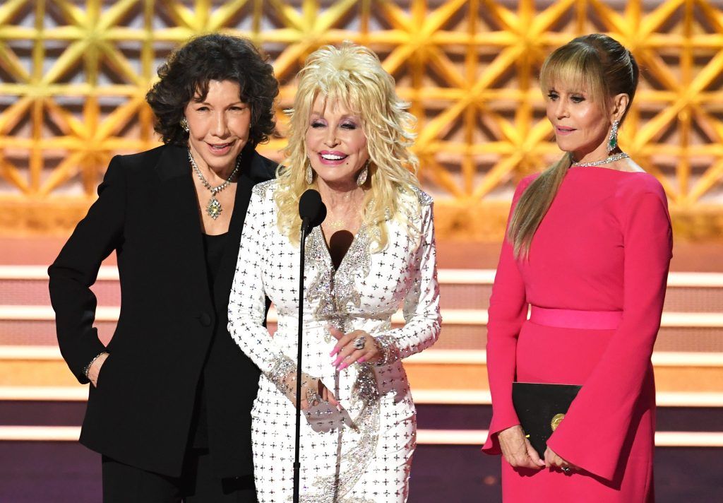 LOS ANGELES, CA - SEPTEMBER 17:  (L-R) Actors Lily Tomlin, Dolly Parton and Jane Fonda speak onstage during the 69th Annual Primetime Emmy Awards at Microsoft Theater on September 17, 2017 in Los Angeles, California.  (Photo by Kevin Winter/Getty Images)
