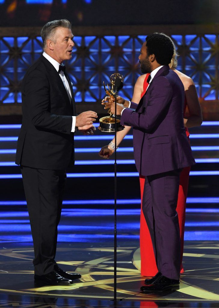 LOS ANGELES, CA - SEPTEMBER 17:  Actor Donald Glover (R) accepts Outstanding Lead Actor in a Comedy Series for 'Atlanta' from actor Alec Baldwin onstage during the 69th Annual Primetime Emmy Awards at Microsoft Theater on September 17, 2017 in Los Angeles, California.  (Photo by Kevin Winter/Getty Images)