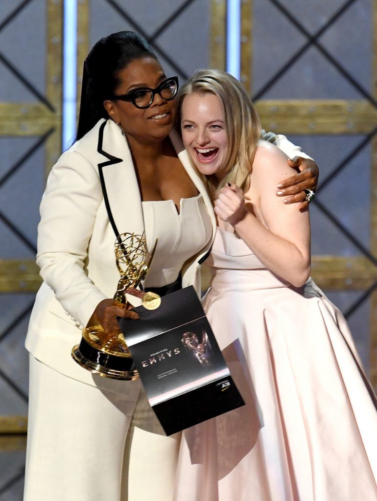 LOS ANGELES, CA - SEPTEMBER 17:  Actor Elisabeth Moss (R) accepts Outstanding Drama Series for 'The Handmaid's Tale' from Oprah Winfrey onstage during the 69th Annual Primetime Emmy Awards at Microsoft Theater on September 17, 2017 in Los Angeles, California.  (Photo by Kevin Winter/Getty Images)