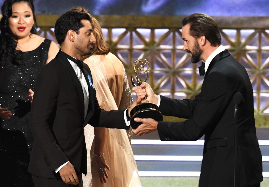 LOS ANGELES, CA - SEPTEMBER 17:  Actor Riz Ahmed (L) accepts the Outstanding Lead Actor in a Limited Series or Movie award for "The Night Of" from actor Joseph Fiennes onstage during the 69th Annual Primetime Emmy Awards at Microsoft Theater on September 17, 2017 in Los Angeles, California.  (Photo by Kevin Winter/Getty Images)