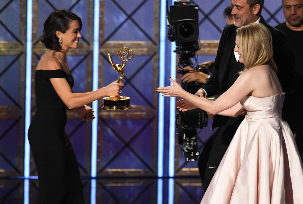 LOS ANGELES, CA - SEPTEMBER 17:  Actor Elisabeth Moss (R) accepts Outstanding Lead Actress in a Drama Series for 'The Handmaid's Tale' from actors Tatiana Maslany and Jeffrey Dean Morgan onstage during the 69th Annual Primetime Emmy Awards at Microsoft Theater on September 17, 2017 in Los Angeles, California.  (Photo by Kevin Winter/Getty Images)