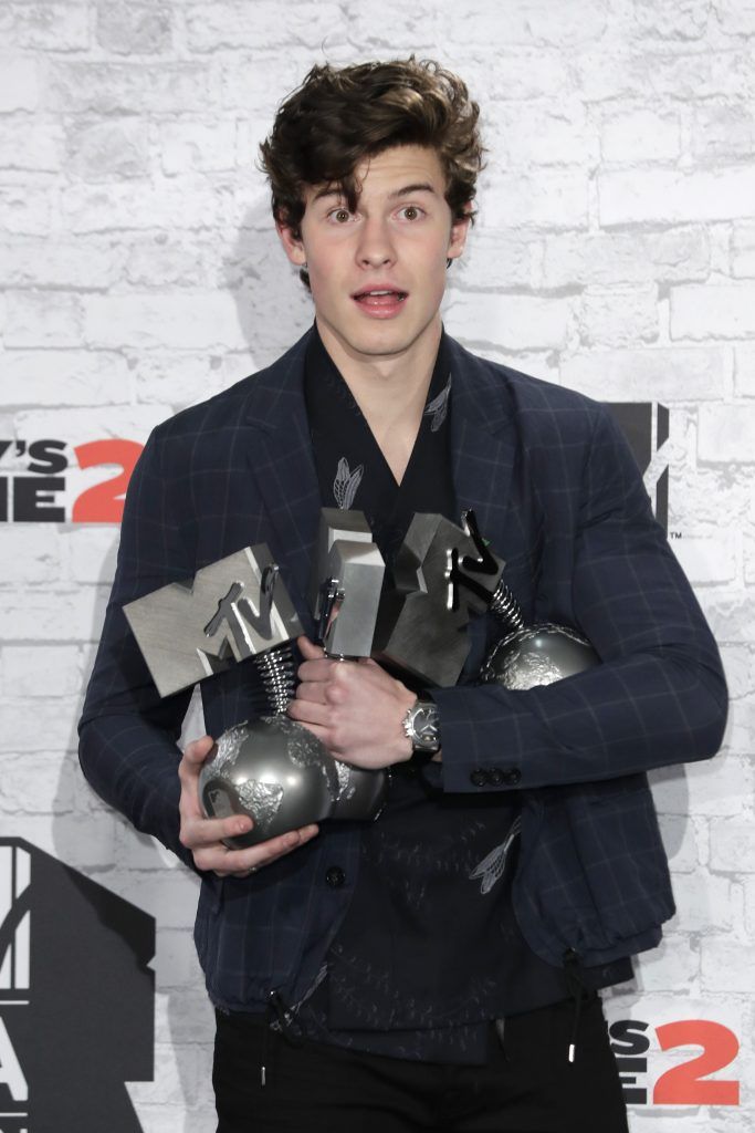 Shawn Mendes poses in the winner's room with awards for Biggest Fans, Best Artist and Best Song during the MTV EMAs 2017 held at The SSE Arena, Wembley on November 12, 2017 in London, England.  (Photo by John Phillips/Getty Images for MTV)