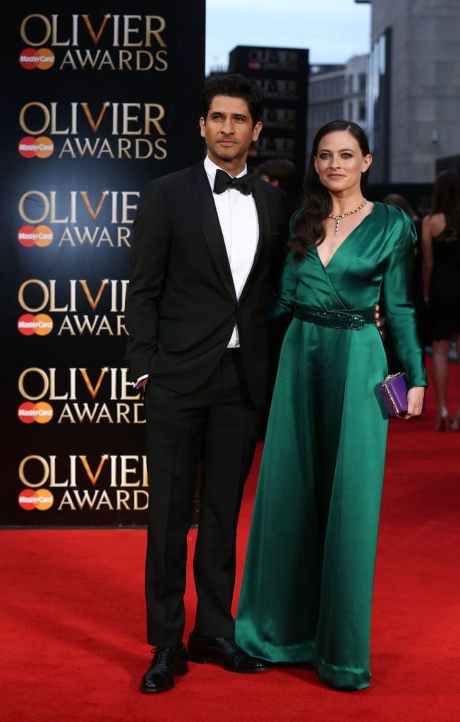 British actress Lara Pulver (R) and husband British actor Raza Jaffrey (L) pose on the red carpet upon arrival to attend the 2016  Laurence Olivier Awards in London on April 3, 2016. / AFP / JUSTIN TALLIS        (Photo credit should read JUSTIN TALLIS/AFP/Getty Images)