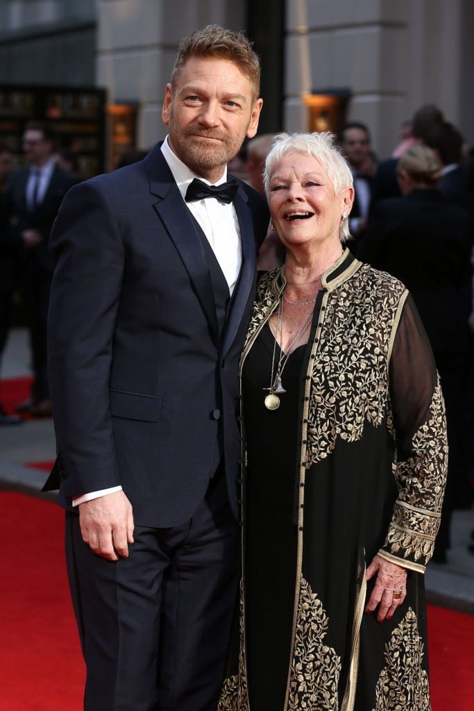 British actor and director Kenneth Branagh (L) and British actress Judi Dench (R) pose on the red carpet upon arrival to attend the 2016  Laurence Olivier Awards in London on April 3, 2016. / AFP / JUSTIN TALLIS        (Photo credit should read JUSTIN TALLIS/AFP/Getty Images)