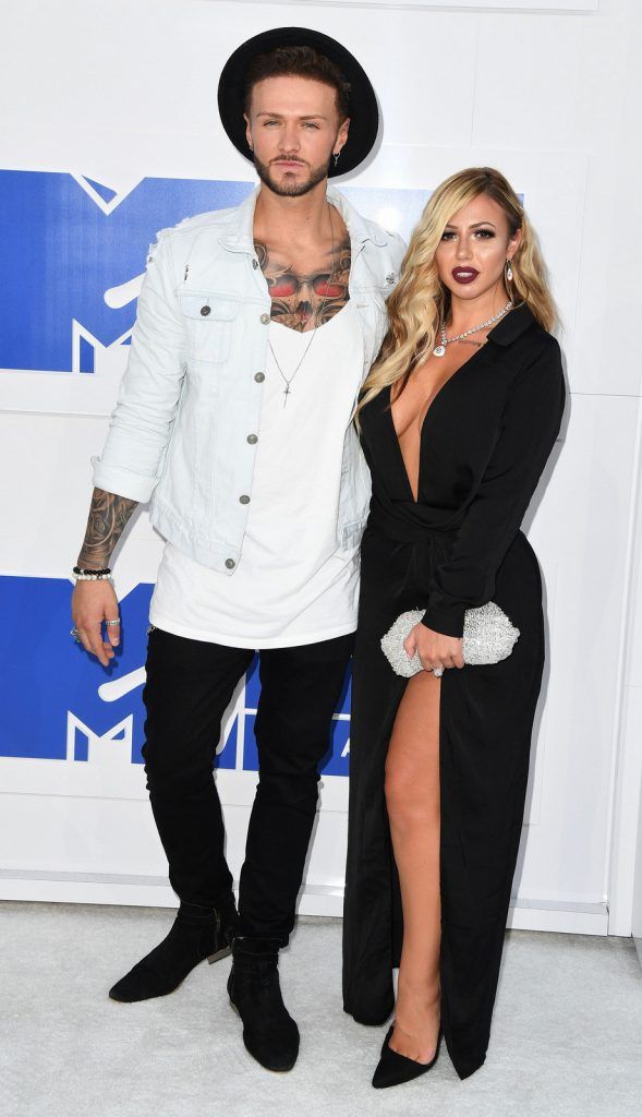 TV personalities Kyle Christie (L) and Holly Hagan arrive for the 2016 MTV Video Music Awards August 28, 2016 at Madison Square Garden in New York. / AFP / Angela Weiss        (Photo credit should read ANGELA WEISS/AFP/Getty Images)