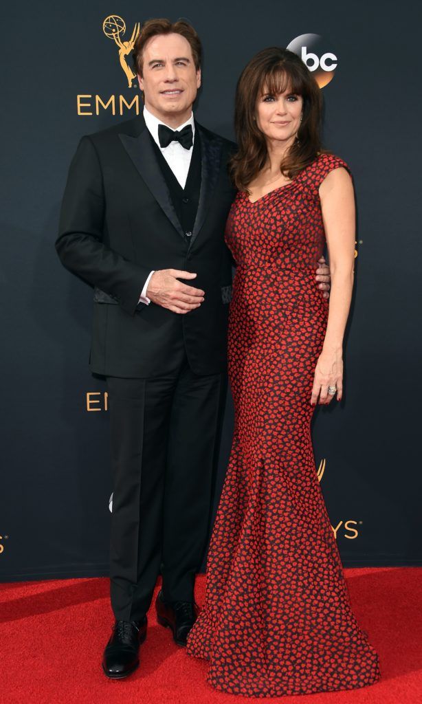 Actors John Travolta (L) and Kelly Preston arrive for the 68th Emmy Awards on September 18, 2016 at the Microsoft Theatre in Los Angeles.  / AFP / Robyn Beck (Photo ROBYN BECK/AFP/Getty Images)