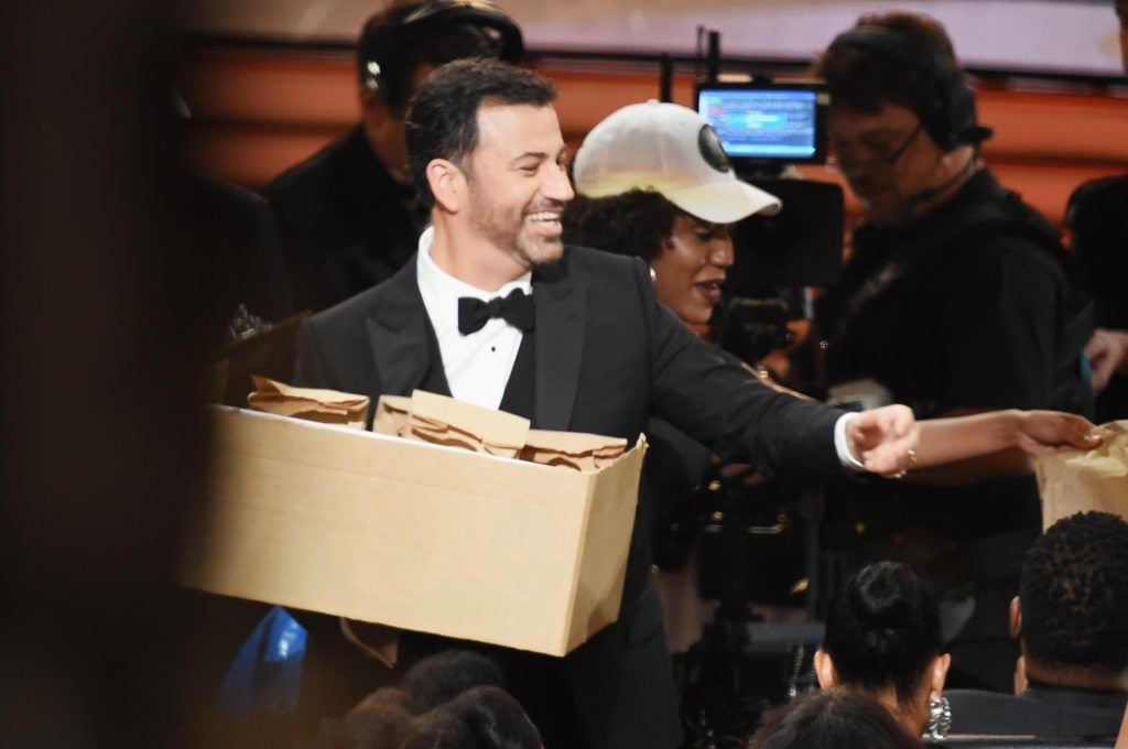 Host Jimmy Kimmel passes out peanut butter and jelly sandwiches to the audience during the 68th Annual Primetime Emmy Awards at Microsoft Theater on September 18, 2016 in Los Angeles, California.  (Photo by Kevin Winter/Getty Images)