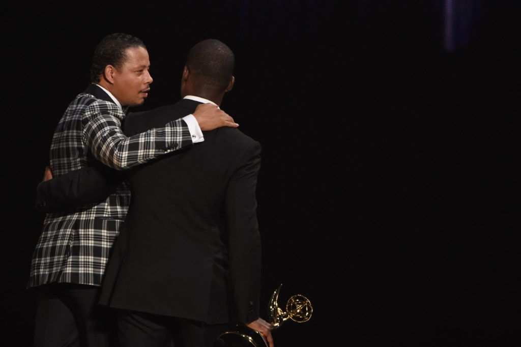 Actor Sterling K. Brown (R) accepts Outstanding Supporting Actor in a Limited Series or Movie for 'The People v. O.J. Simpson: American Crime Story' from actor Terrence Howard onstage during the 68th Emmy Awards show on September 18, 2016 at the Microsoft Theatre in downtown Los Angeles.  / AFP / Valerie MACON        (Photo VALERIE MACON/AFP/Getty Images)