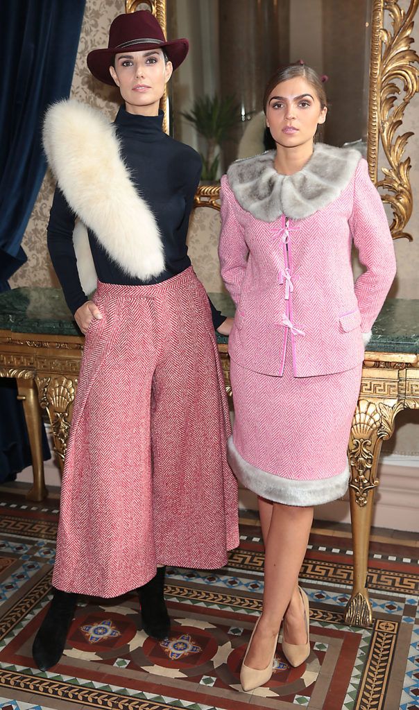 Alison Canavan wears a  red tweed culottes with black top and fur and Ruzena  Kristofova wears  pink tweed suit with grey faux fur by Irish Designer Caitriona Hanly at the Etihad Airways 21st Annual International Fashion Lunch in aid of the Rape Crisis Centre at the Westin Hotel, Dublin (Pictures: Brian McEvoy).