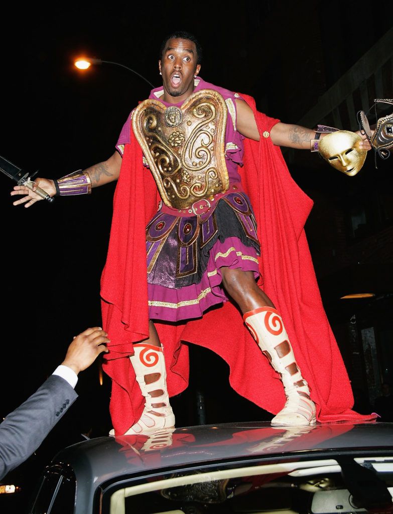 Sean "P. Diddy" Combs stands on top of his Rolls Royce as he attends singer Mariah Carey's Halloween party at Cain October 31, 2004 in New York City.  (Photo by Evan Agostini/Getty Images)
