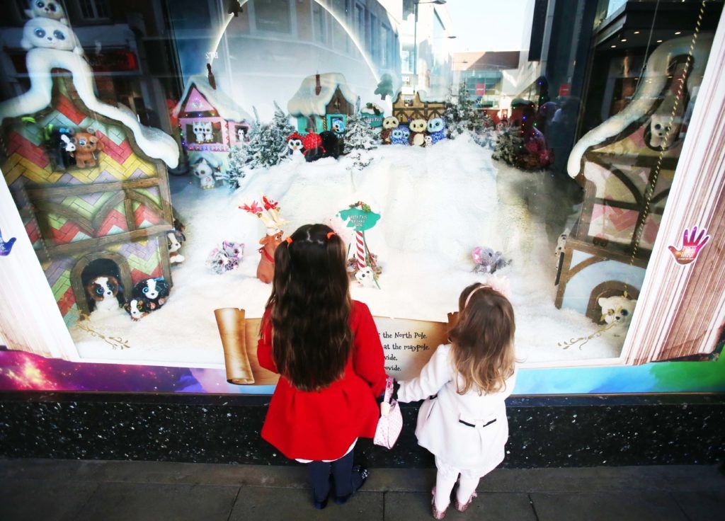 Pictured are Saoirse (3) and Caoimhe (5) Armstrong as Arnotts unveiled their iconic Christmas Windows, which reveal Santa's newest reindeer, Crackers, and also a pop up Tayto Crispmas Workshop. Photograph: Leon Farrell / Photocall Ireland