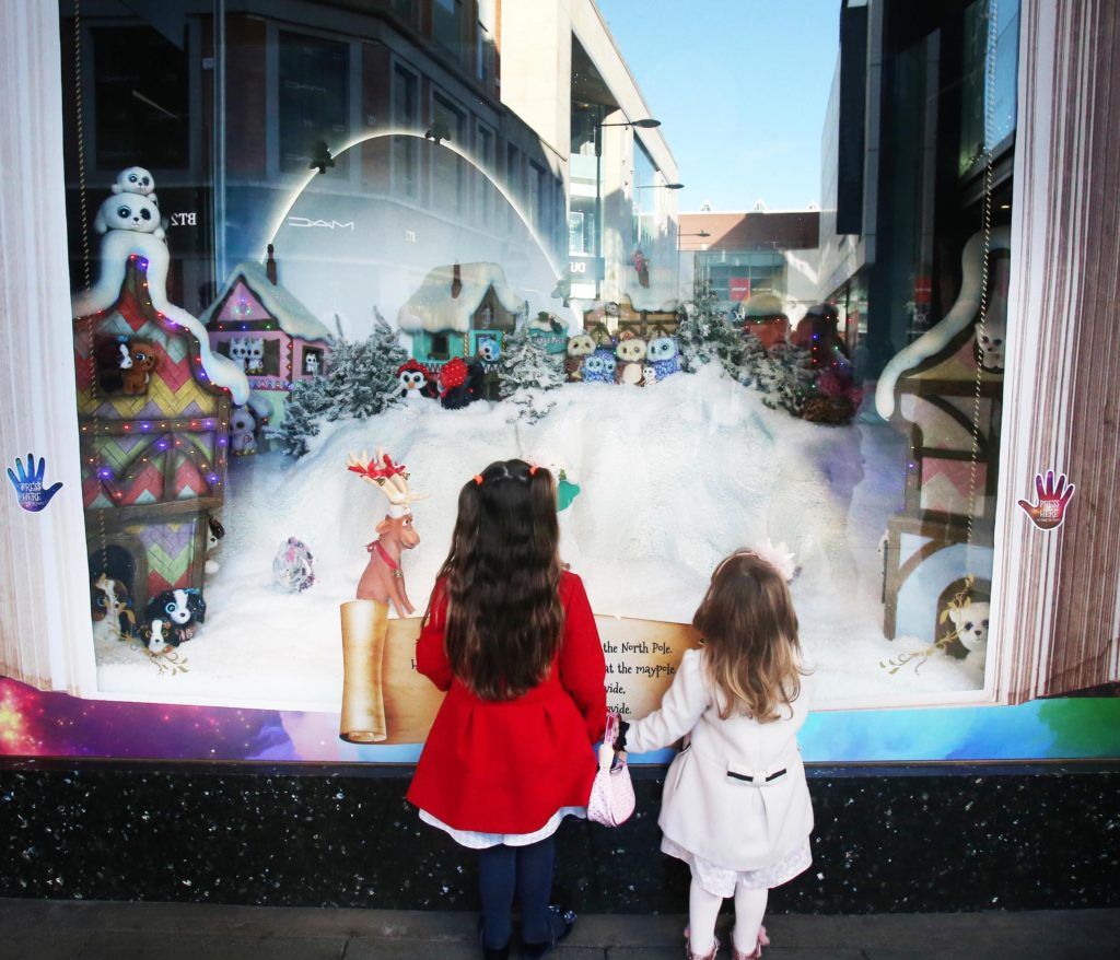 Pictured are Saoirse (3) and Caoimhe (5) Armstrong as Arnotts unveiled their iconic Christmas Windows, which reveal Santa's newest reindeer, Crackers, and also a pop up Tayto Crispmas Workshop. Photograph: Leon Farrell / Photocall Ireland