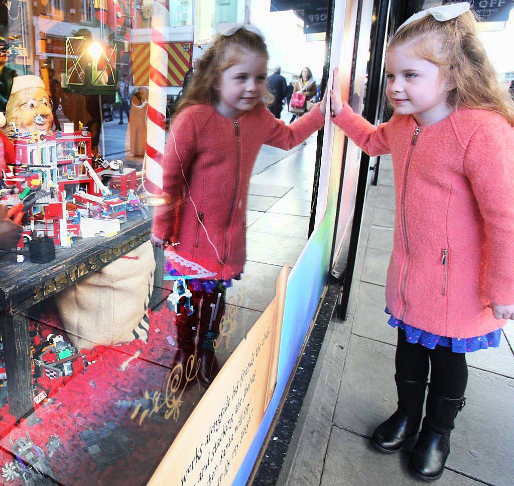 Pictured is Chloe Dalton (7) as Arnotts unveiled their iconic Christmas Windows, which reveal Santa's newest reindeer, Crackers, and also a pop up Tayto Crispmas Workshop. Photograph: Leon Farrell / Photocall Ireland