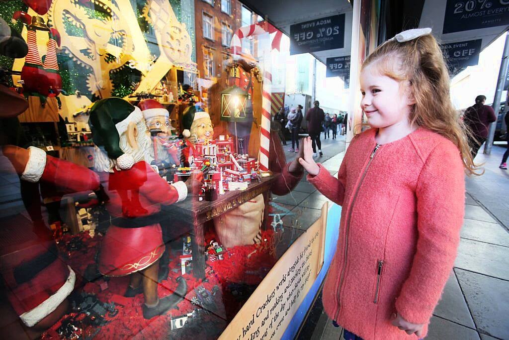 Pictured is Chloe Dalton (7) as Arnotts unveiled their iconic Christmas Windows, which reveal Santa's newest reindeer, Crackers, and also a pop up Tayto Crispmas Workshop. Photograph: Leon Farrell / Photocall Ireland