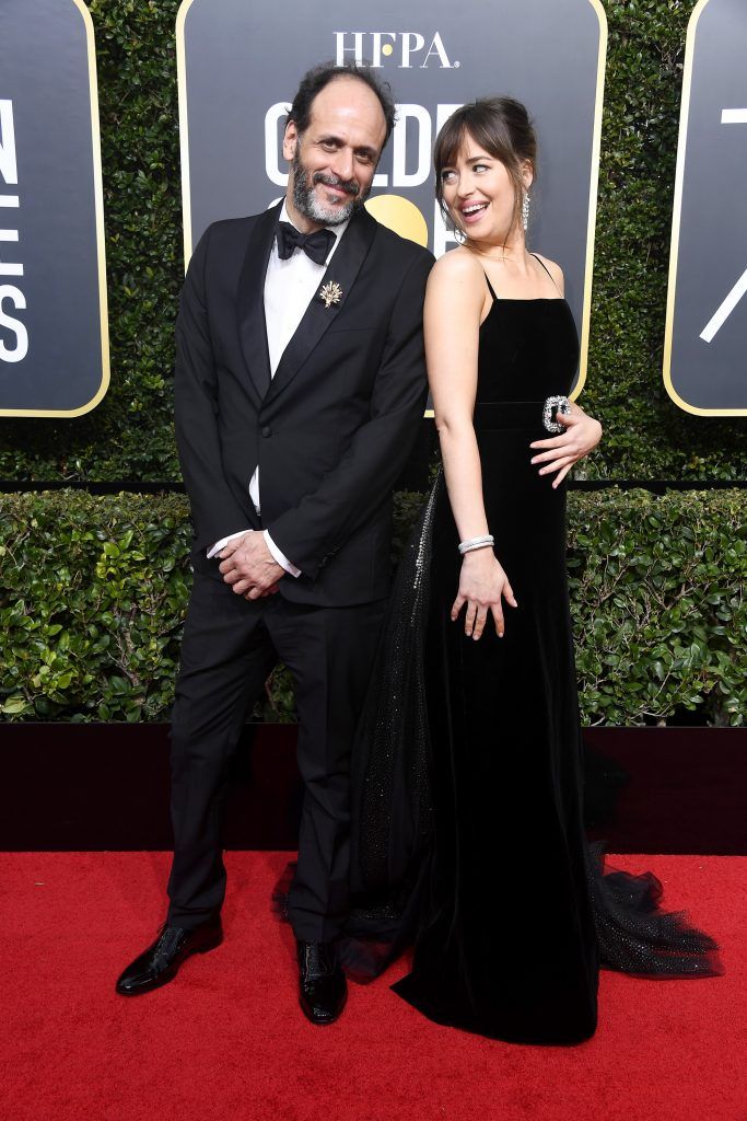 BEVERLY HILLS, CA - JANUARY 07:  Director Luca Guadagnino (L) and actor Dakota Johnson attend The 75th Annual Golden Globe Awards at The Beverly Hilton Hotel on January 7, 2018 in Beverly Hills, California.  (Photo by Frazer Harrison/Getty Images)