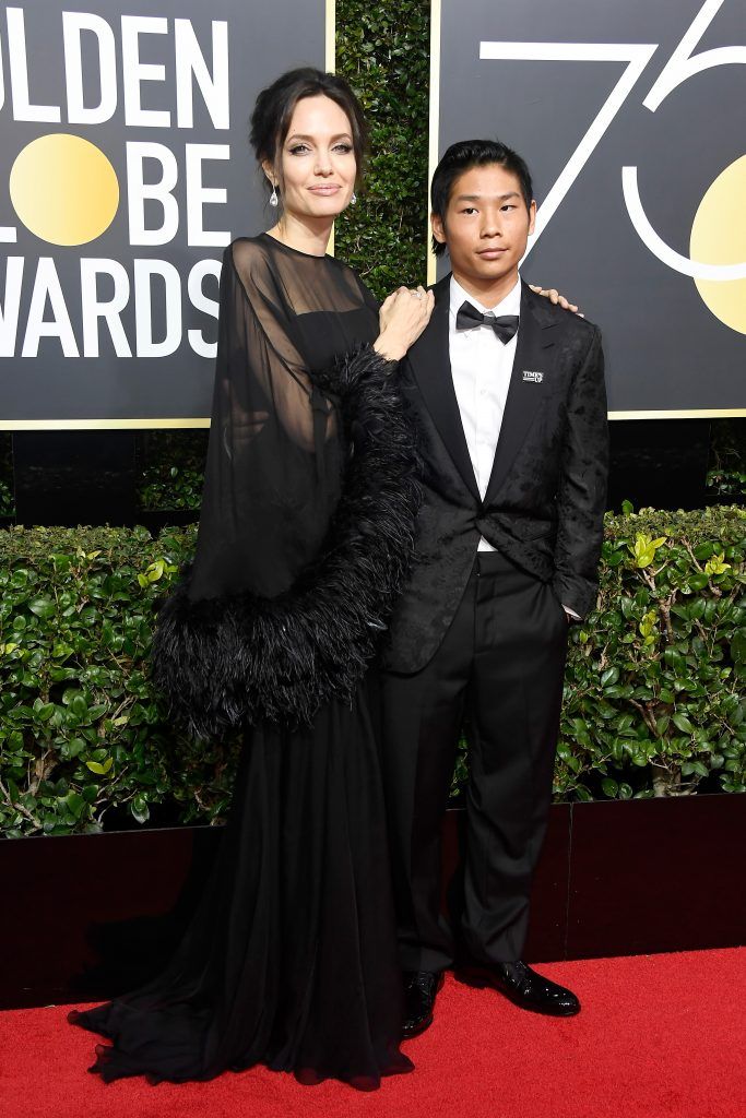 BEVERLY HILLS, CA - JANUARY 07:  Actor/director Angelina Jolie (L) and Pax Thien Jolie-Pitt attend The 75th Annual Golden Globe Awards at The Beverly Hilton Hotel on January 7, 2018 in Beverly Hills, California.  (Photo by Frazer Harrison/Getty Images)