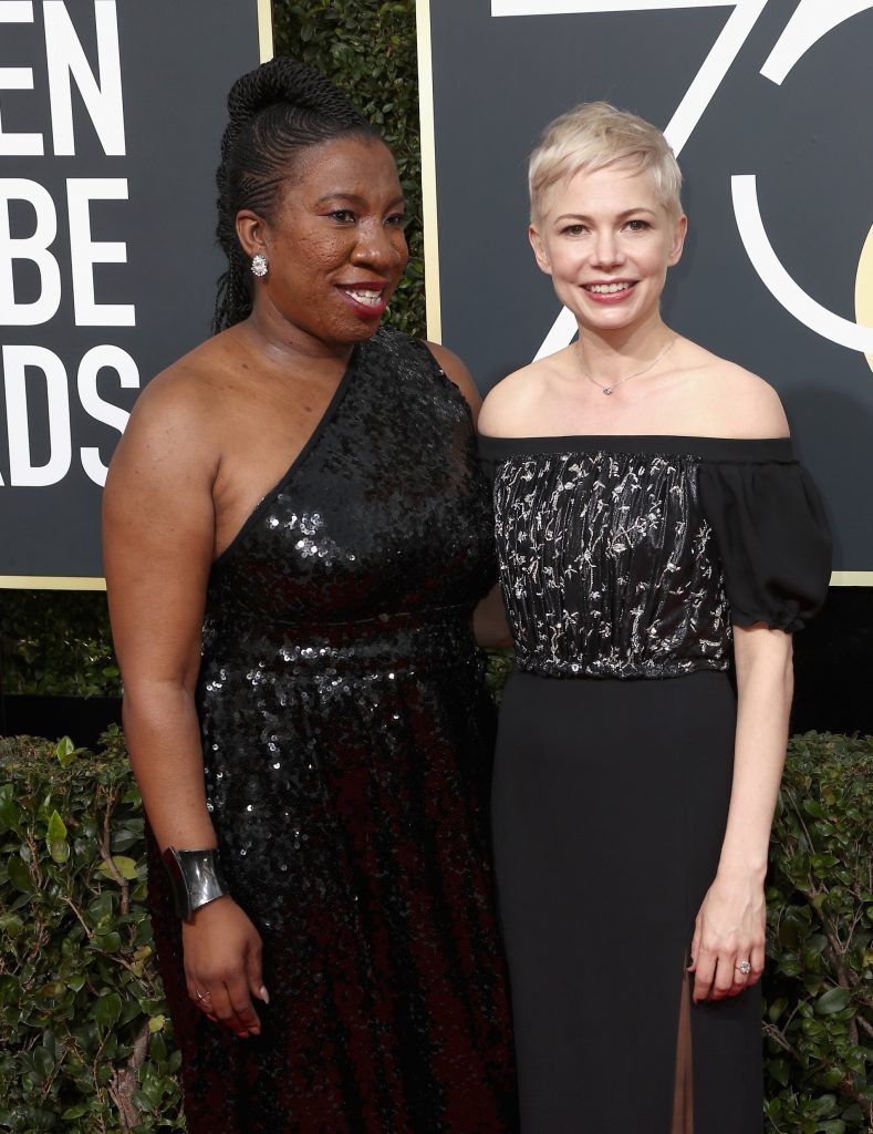 BEVERLY HILLS, CA - JANUARY 07:  Activist Tarana Burke (L) and actor Michelle Williams attend The 75th Annual Golden Globe Awards at The Beverly Hilton Hotel on January 7, 2018 in Beverly Hills, California.  (Photo by Frederick M. Brown/Getty Images)