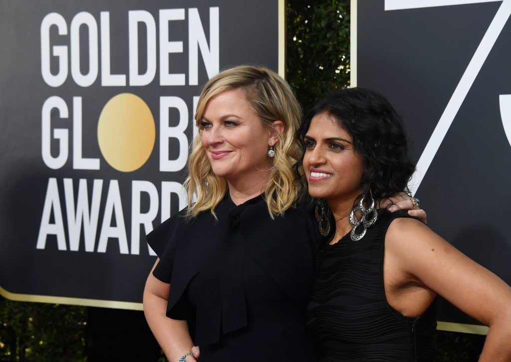 BEVERLY HILLS, CA - JANUARY 07:  Actor Amy Poehler (L) and activist Saru Jayaraman attend The 75th Annual Golden Globe Awards at The Beverly Hilton Hotel on January 7, 2018 in Beverly Hills, California.  (Photo by Frazer Harrison/Getty Images)