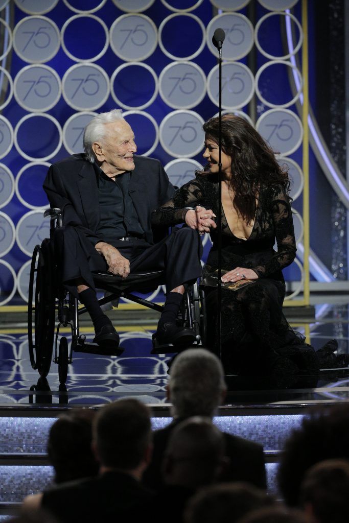 BEVERLY HILLS, CA - JANUARY 07:  In this handout photo provided by NBCUniversal, Presenters Kirk Douglas and Catherine Zeta Jones speak onstage during the 75th Annual Golden Globe Awards at The Beverly Hilton Hotel on January 7, 2018 in Beverly Hills, California.  (Photo by Paul Drinkwater/NBCUniversal via Getty Images)