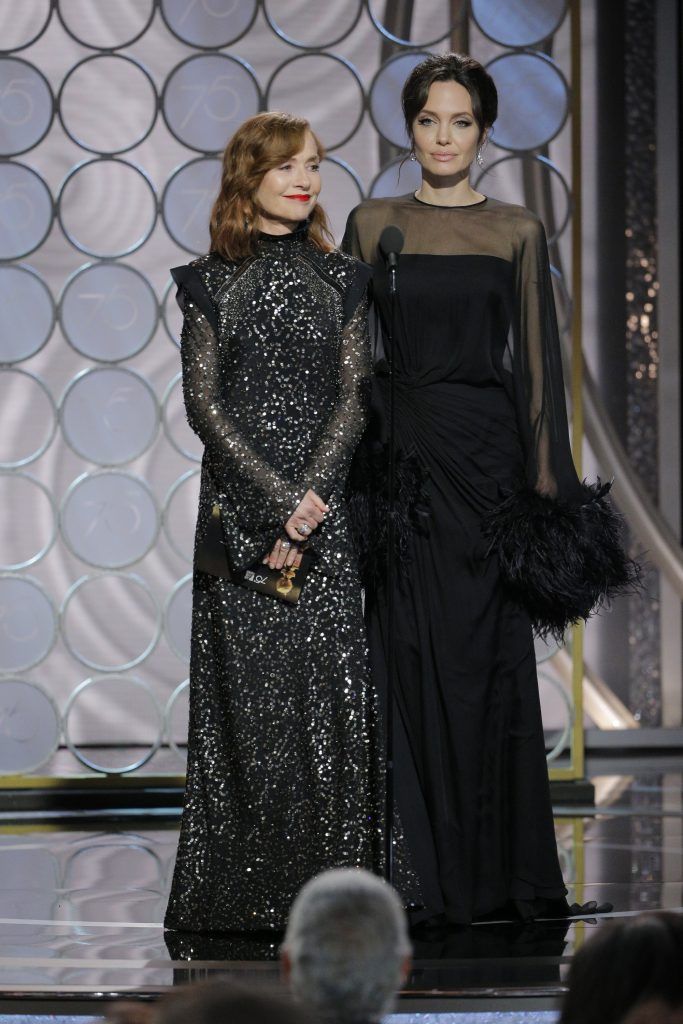 BEVERLY HILLS, CA - JANUARY 07:  In this handout photo provided by NBCUniversal,  Presenters Isabelle Huppert and  Angelina Jolie speak onstage during the 75th Annual Golden Globe Awards at The Beverly Hilton Hotel on January 7, 2018 in Beverly Hills, California.  (Photo by Paul Drinkwater/NBCUniversal via Getty Images)