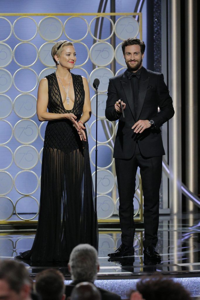 BEVERLY HILLS, CA - JANUARY 07:  In this handout photo provided by NBCUniversal, Kate Hudson and Aaron Taylor Johnson speak onstage during the 75th Annual Golden Globe Awards at The Beverly Hilton Hotel on January 7, 2018 in Beverly Hills, California.  (Photo by Paul Drinkwater/NBCUniversal via Getty Images)