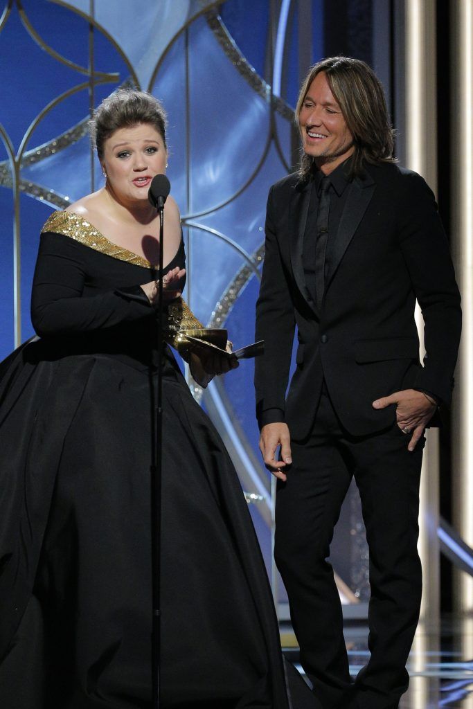 BEVERLY HILLS, CA - JANUARY 07:  In this handout photo provided by NBCUniversal,  Presenters Kelly Clarkson and Keith Urban  speak onstage during the 75th Annual Golden Globe Awards at The Beverly Hilton Hotel on January 7, 2018 in Beverly Hills, California.  (Photo by Paul Drinkwater/NBCUniversal via Getty Images)