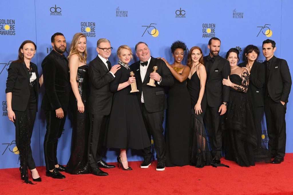 BEVERLY HILLS, CA - JANUARY 07:  (L-R) Actors Alexis Bledel, O-T Fagbenle, Yvonne Strahovski, Producers Warren Littlefield, Elisabeth Moss, Bruce Miller, actors Samira Wiley, Madeline Brewer, Joseph Fiennes, Ann Dowd, Reed Morano and Max Minghella of 'The Handmaid's Tale' pose with their awards for Best Television Series Drama in the press room during The 75th Annual Golden Globe Awards at The Beverly Hilton Hotel on January 7, 2018 in Beverly Hills, California.  (Photo by Kevin Winter/Getty Images)
