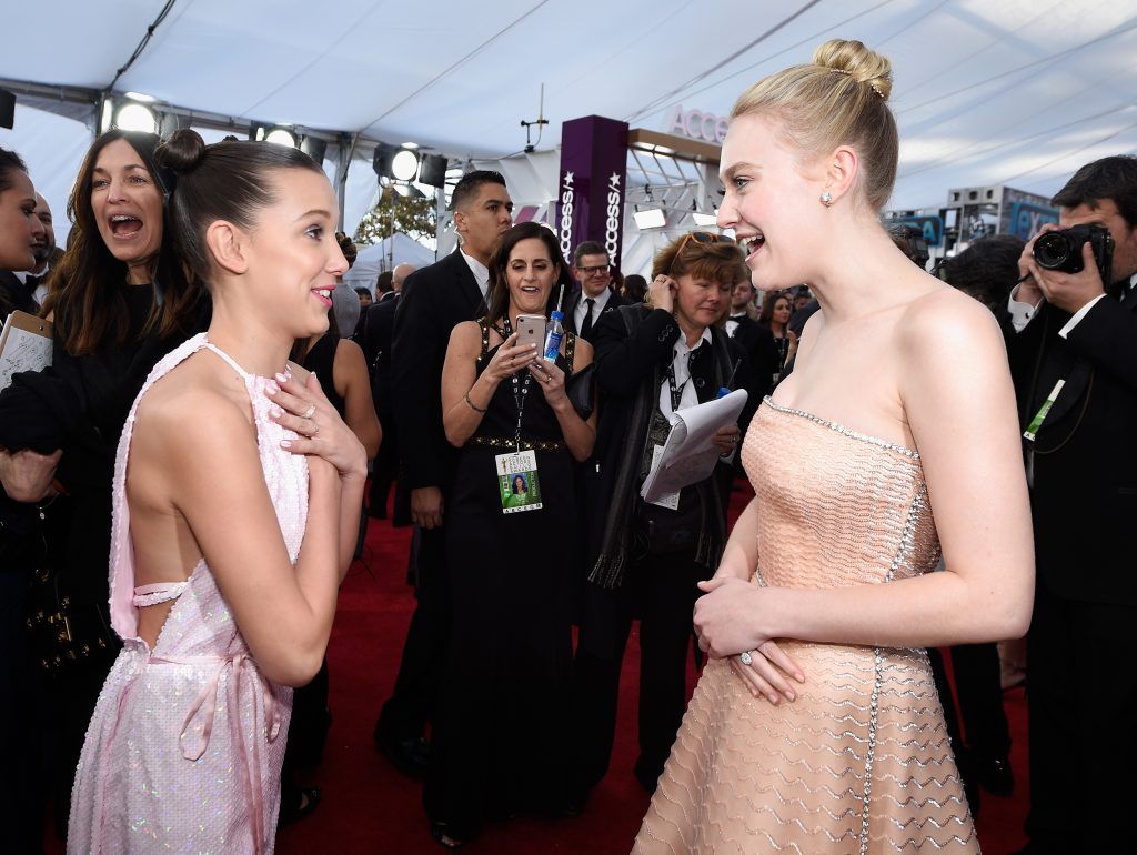 LOS ANGELES, CA - JANUARY 21:  Actors Millie Bobby Brown (L) and Dakota Fanning attend the 24th Annual Screen Actors Guild Awards at The Shrine Auditorium on January 21, 2018 in Los Angeles, California.  (Photo by Kevork Djansezian/Getty Images)