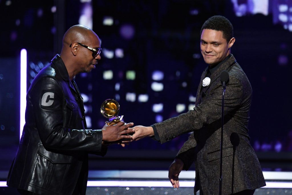 Comedian Dave Chappelle (L) accepts Best Comedy Album for 'The Age of Spin'/'Deep in the Heart of Texas' from TV personality Trevor Noah onstage during the 60th Annual GRAMMY Awards at Madison Square Garden on January 28, 2018 in New York City.  (Photo by Kevin Winter/Getty Images for NARAS)