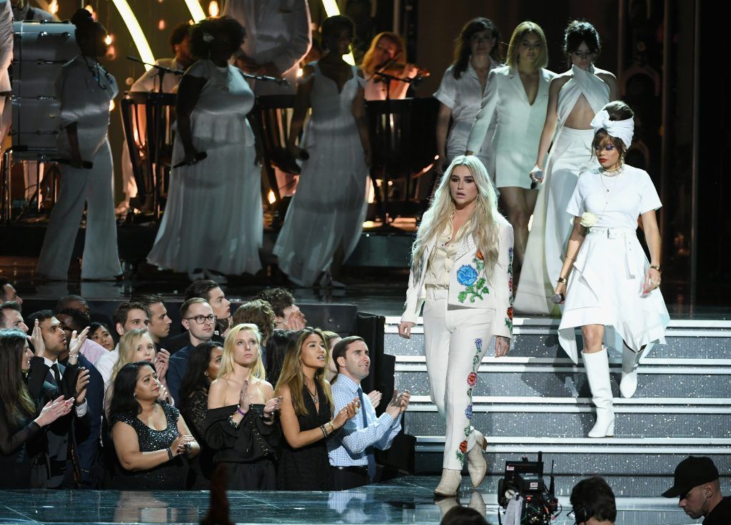 Recording artist Kesha (foreground) walks onstage with Andra Day, Camila Cabello, Julia Michaels, and chorus members during the 60th Annual GRAMMY Awards at Madison Square Garden on January 28, 2018 in New York City.  (Photo by Kevin Winter/Getty Images for NARAS)