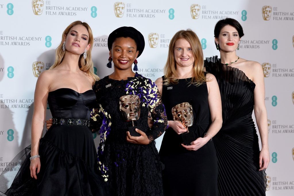 Lily James (L) and Gemma Arterton (R) and Rungano Nyoni (2ndL) and Emily Morgan (2ndR) pose in the press room during the EE British Academy Film Awards (BAFTA) held at Royal Albert Hall on February 18, 2018 in London, England.  (Photo by Jeff Spicer/Jeff Spicer/Getty Images)