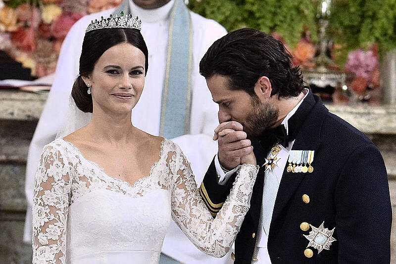 Sweden's Prince Carl Philip (R) kisses Sofia Hellqvist's hand during their wedding ceremony at the Royal Chapel in Stockholm Palace on June 13, 2015. AFP PHOTO / TT NEWS AGENCY /  CLAUDIO BRESCIANI  SWEDEN OUT        (Photo credit should read Claudio Bresciani/AFP/Getty Images)