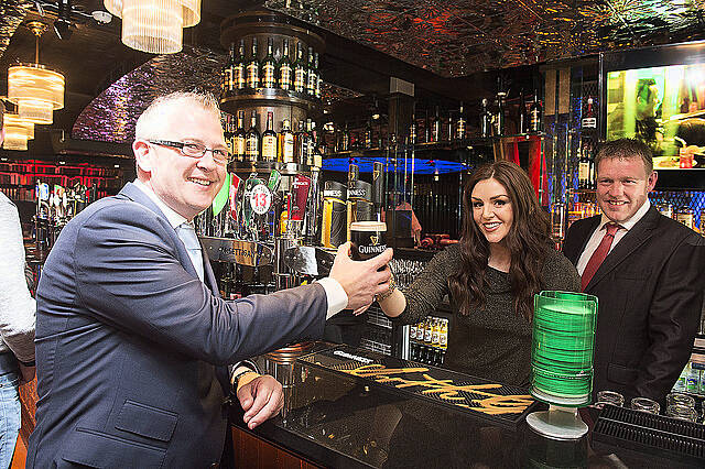 Dennis McGettigan gets served by Sile Seoige under the watchful eye of Mixer Dooley  at the opening of  McGettigan's Galway located off Eyre Square on Prospect HIll. The venue marks an investment of 2.5meuro and employment  for up to 50 people. McGettigans in Galway joins 10 other McGettigans located in Dubai (3) , Abu Dhabi, Fujairah,Dublin, Limerick, Donegal, Singapore, New York. Two more McGettigans in London and
Bahrain will  open in 2015.
  Photo:Andrew Downes XPOSURE