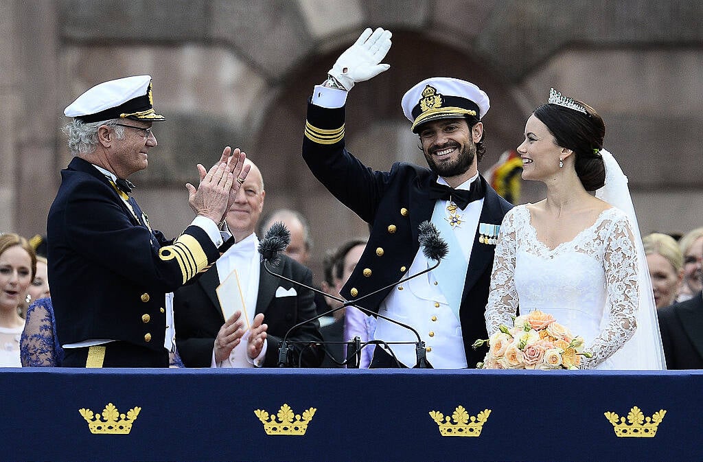 Sweden's King Carl XVI Gustaf (L) applauds the newly wed couple Sweden's Princess Sofia (R) and Sweden's Prince Carl Philip after their wedding ceremony at Stockholm Palace on June 13, 2015. AFP PHOTO / JONATHAN NACKSTRAND        (Photo credit should read JONATHAN NACKSTRAND/AFP/Getty Images)