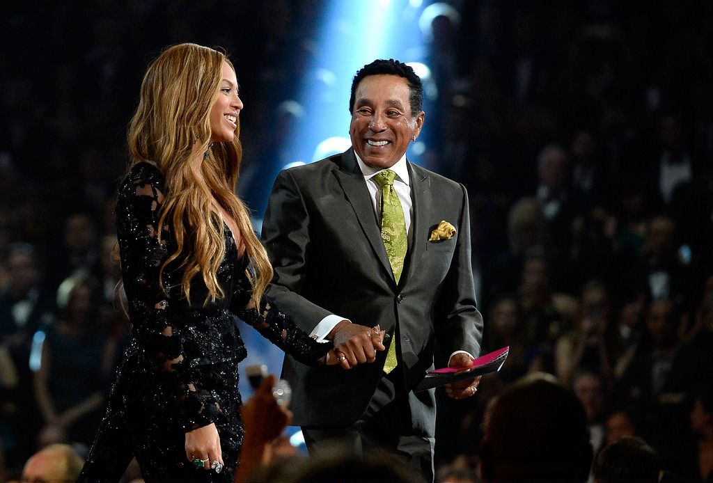 Singer Beyonce (L) accepts the Best R&B Performance for "Drunk In Love" from singer Smokey Robinson onstage during The 57th Annual GRAMMY Awards at the at the STAPLES Center on February 8, 2015 in Los Angeles, California.  (Photo by Kevork Djansezian/Getty Images)