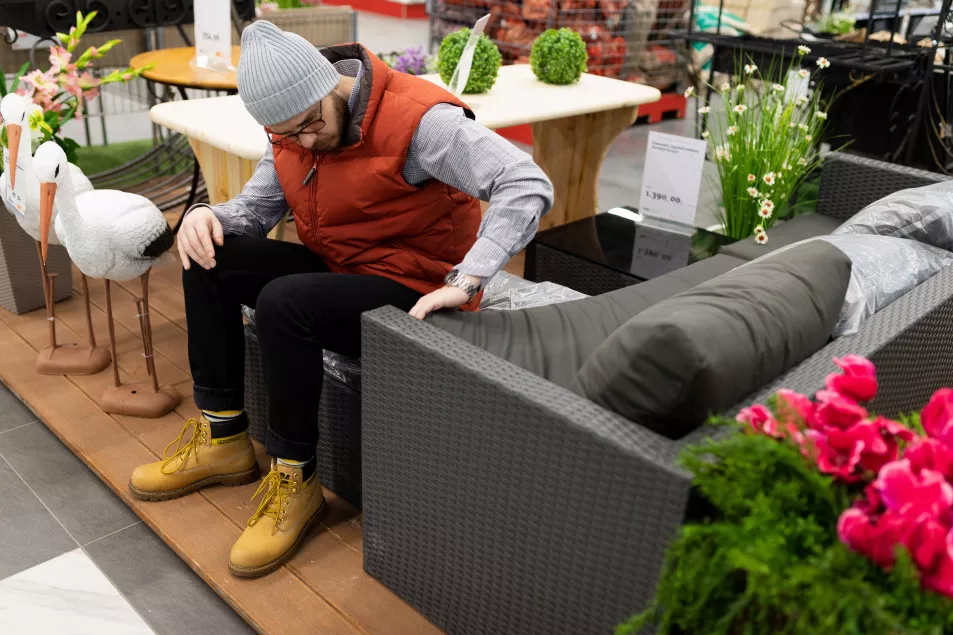 Man looking at garden furniture in a shop