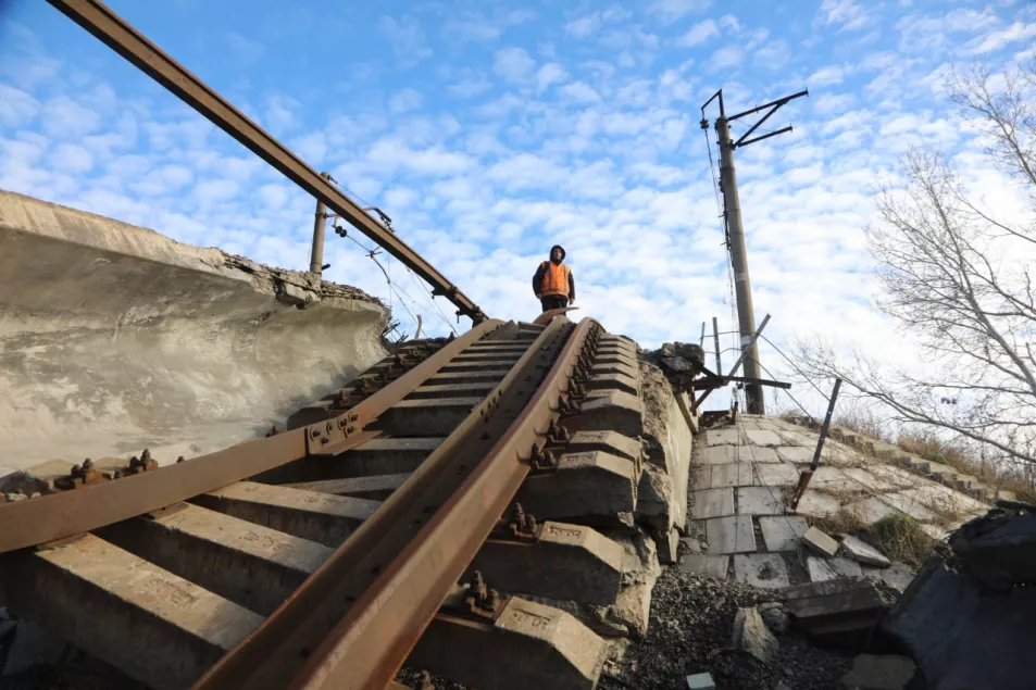 EMBARGOED 00.01 FEB 21 A railway worker stares down a bombed train track in Ukraine's Donetsk region. (Department for Transport)
