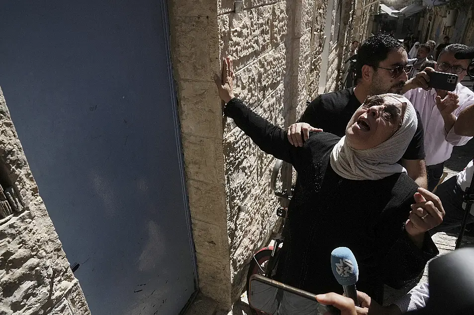 Nora Ghaith-Sub Laban touches the door to her home 