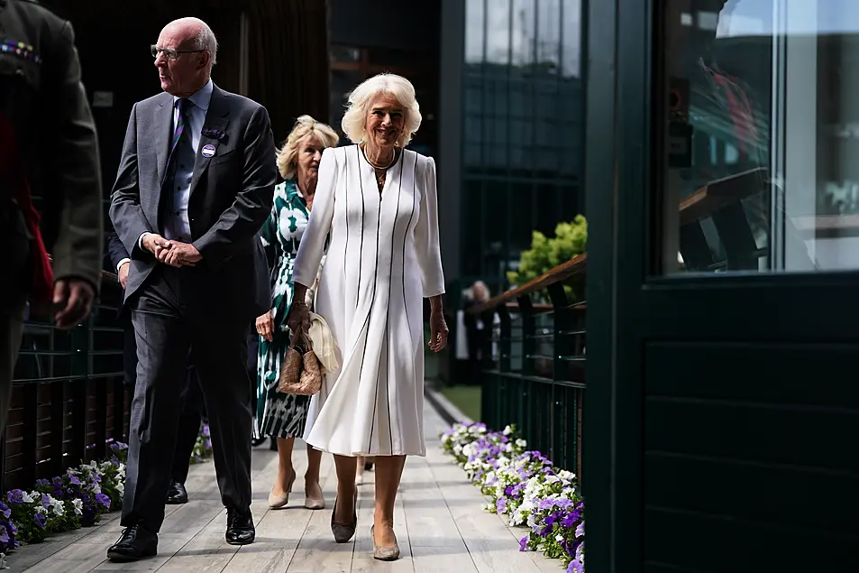 Queen Camilla with AELTC chairman, Ian Hewitt as she arrives for her visit on day ten of the 2023 Wimbledon Championships