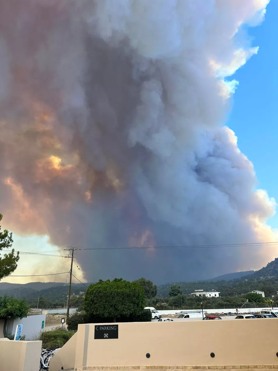 A large plume of smoke in the sky from the wildfires on Rhodes