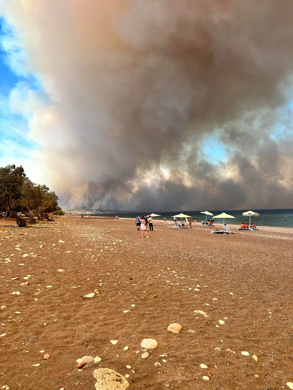 A large plume of smoke over a beach on Rhodes
