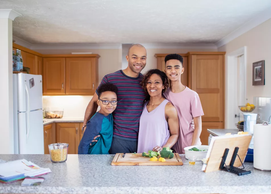 A family in the kitchen preparing a healthy meal