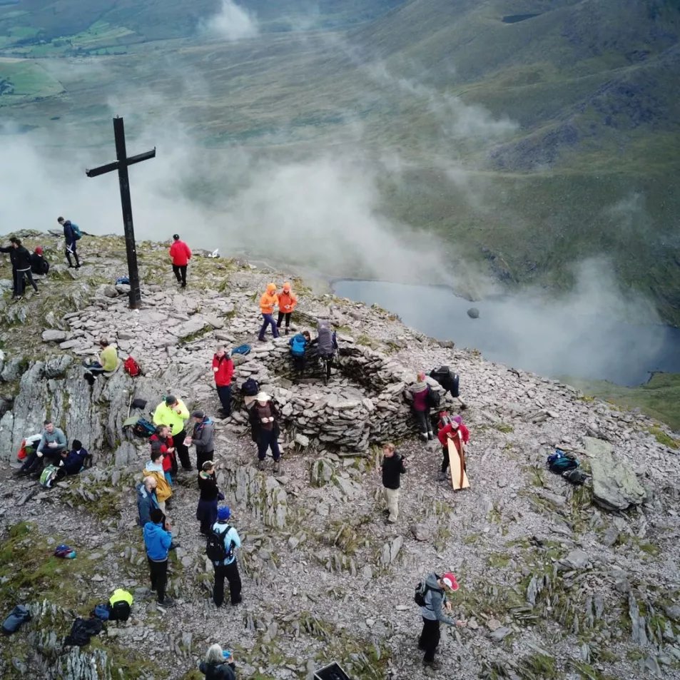 Image of a cross and the top of a mountain 