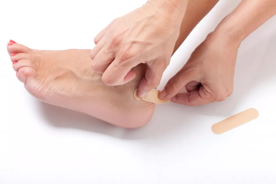 person putting on blister plaster