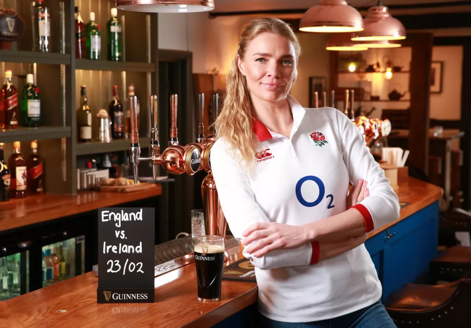 Jodie Kidd standing at the bar in her pub