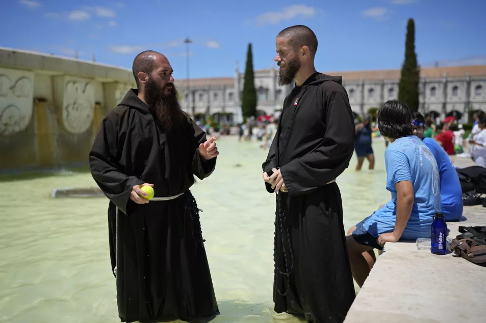 Two priests in front of the Jeronimos Monastery