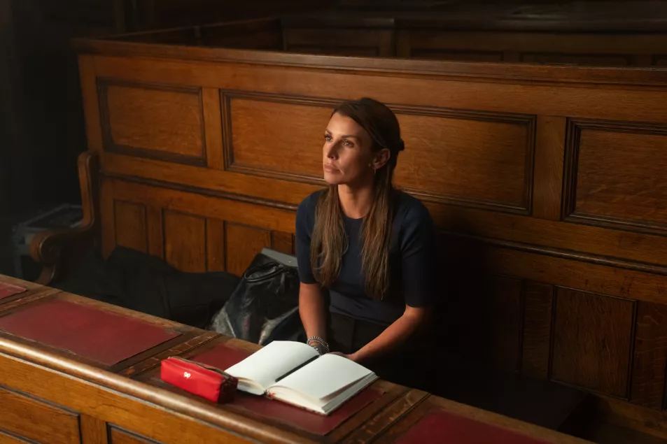 Close up of Coleen Rooney in a court room with a notebook open in front of her