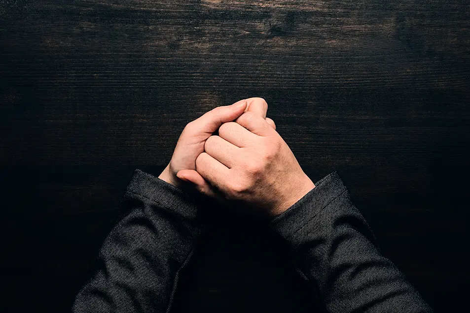 hands wringing at office desk